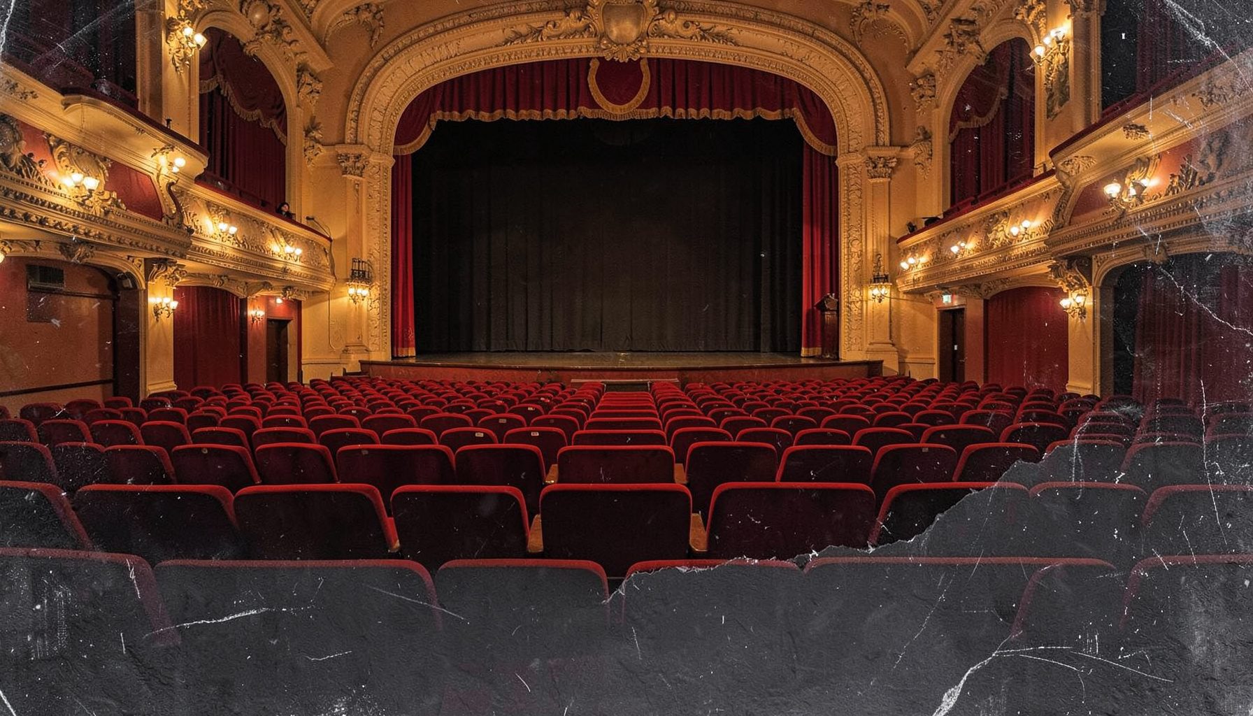 A grand theater interior with rows of red velvet seats, warm golden lighting, and an ornate proscenium arch framing the stage